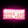 Nail technician humor with bright, neon signs in a salon setting.