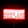 Nail technician with a humorous neon sign background