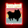 Pomeranian with owner, displaying a colorful neon sign reading 'Sorry I can't, I have agility with my pomeranian'.