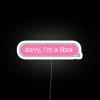 A neon pink Libra sign on a phone message background.