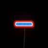 Neon sign with colorful digital letters reading 'Sorry, I'm late, I saw a dog.'