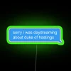 Neon sign with green letters spelling out 'Sorry, I was daydreaming about the Duke of Hastings'