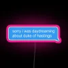 Neon sign featuring the Duke of Hastings character from the popular book series, illuminated in pink with a playful daydre...