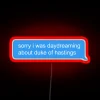 A neon sign reading "Sorry, I was daydreaming about the Duke of Hastings" in bright red letters.