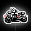 Neon-lit motorbike helmet with colorful LED lights on a sleek, white background.