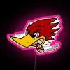Neon pink speed thrush sign in a vibrant cityscape at night.