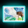 Spirited Away characters Haku and Chihiro illuminated in neon colors under a city sign