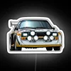 Retro-style neon sign featuring a white Audi Sport Quattro S1 rally car with bright, glowing colors.