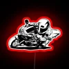 Neon-lit motorcycle taking a sharp turn on a winding road.