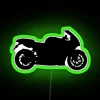 Neon-lit sport bike silhouette at night.