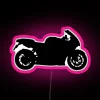 Neon-lit sport bike silhouette at night with pink glow.