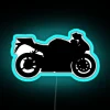 Neon-lit silhouette of a sport bike at night.