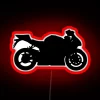 Neon-lit sport bike silhouette against a dark city street.