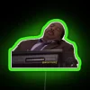 Neon sign reading 'Stanley Hudson' in green letters on a dark background.