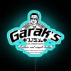 A neon sign reading 'Garak's Tailor' from the TV show Star Trek: Deep Space Nine.