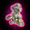 A statue of an elf with neon highlights, depicted with a large smile and nose, and oversized ears, standing on a rock.