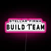 Neon sign reading "Firma Build Team Stellar" in dark RGB colors with pink accents.
