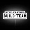 Team of skilled professionals working together in a futuristic office space with neon lights.