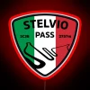 Stelvio Pass mountain road with a motorcycle under an LED RGB neon sign at night
