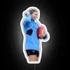 AFL player Steph Catley holds a ball in front of a colorful neon sign.