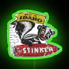 Neon sign with bright green letters reading 'Stinker Gas'