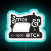 Neon sign advertising a sewing machine store with a playful stitching pun.
