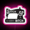 Neon sign featuring a sewing machine with a pink stitch pattern, conveying a fun and creative atmosphere.
