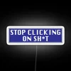 Neon sign with bold, cursive lettering in shades of pink, blue, and green reading 'Stop Clicking on Sh*t'