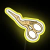 Neon sign with LED lights, stork scissors and gold accents in yellow color.
