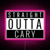 Neon sign reading 'Straight Outta Cary, NC' with pink and RGB lights in a North Carolina cityscape.