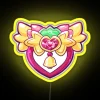 Vibrant Tokyo city street sign featuring strawberries, bells, and Mew Mew logo in neon colors.