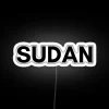 Sudanese cityscape with vibrant neon lights at dusk.