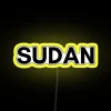 Neon sign in Sudan with yellow and blue lights at night.
