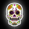 Neon sugar skull decoration in a festive Mexican-inspired Halloween setting.