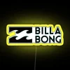 Billabong clothing, summer short with neon sleeve, adventure-inspired design on a yellow background.