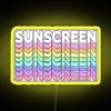 Neon yellow sunscreen advertisement on a digital sign.