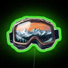 Skier on mountain slope during sunset, wearing ski goggles and sledding gear.