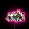 Neon pink sign with glowing, supernatural-themed cartoon design