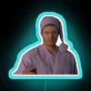 Dean Winchester from Supernatural posing in front of an RGB neon sign.