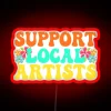 Neon sign supporting local artists for music lovers in vibrant colors.