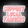 Neon sign reading 'Support Local Farmers' in colorful RGB lighting.
