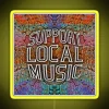 Neon sign reading 'Support Local Music' in bright yellow letters.