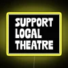 Neon sign promoting support for local theatre, colorful and eye-catching.