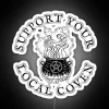 Witchcraft store neon sign with colorful, glowing letters spelling out 'Support Your Local Coven'