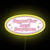 Supporting local drag queens with vibrant neon lights in a colorful urban setting.