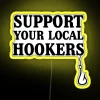 Neon sign reading 'Support Your Local Hookers Fishermen' with colorful LED lights in a vibrant yellow and blue hue.