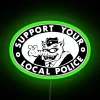 Neon sign with green letters reading "Support Your Local Police" in bold, RGB colors.
