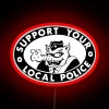 Neon sign reading 'Support Your Local Police' in red, blue, and green hues.
