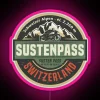 Susten Pass neon sign at dusk with vibrant pink hue
