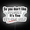 Neon sign with punny phrase 'Sut-Ure Self Surgery'